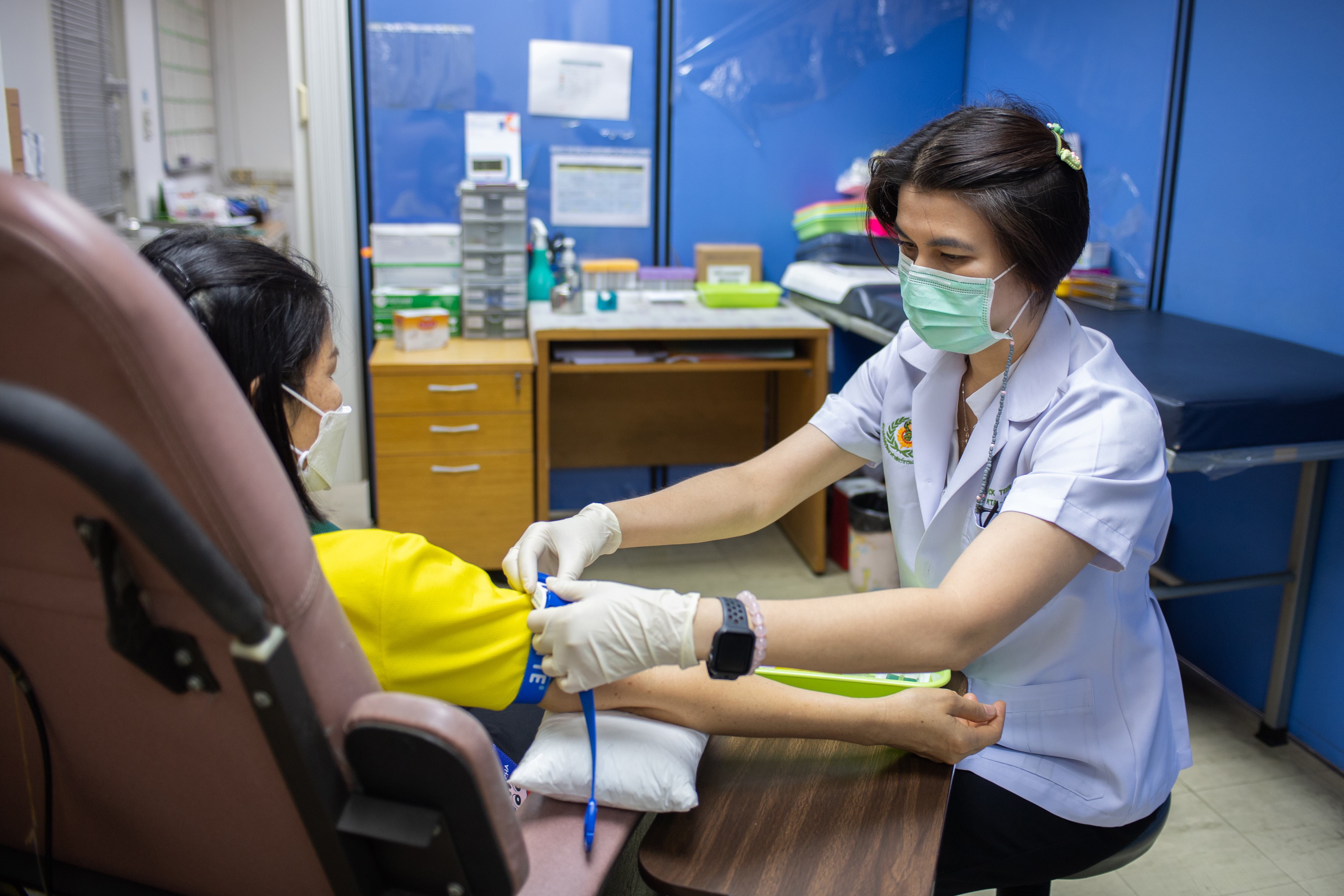 A nurse prepares a participant for a blood draw